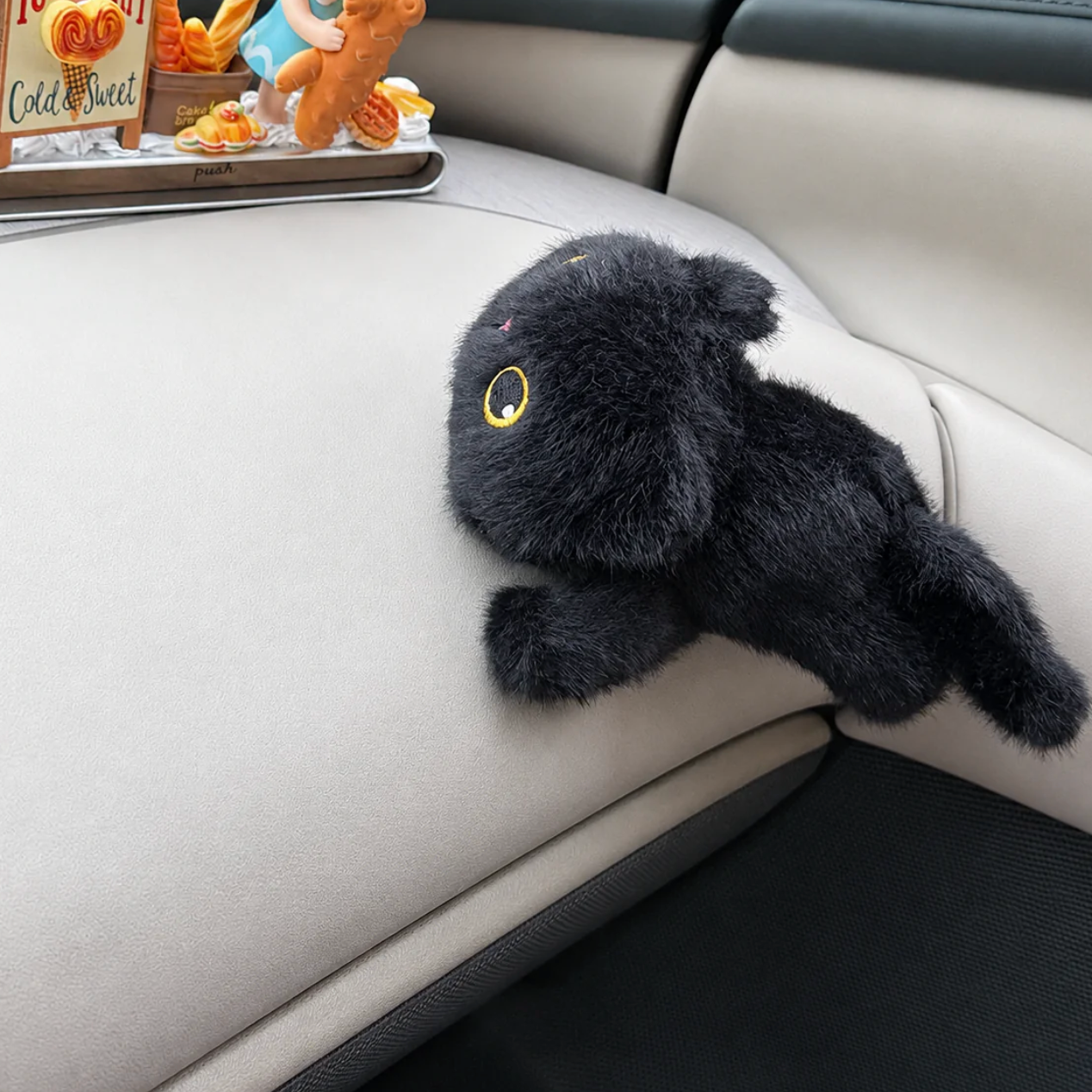 Black plush cat toy with yellow eyes
