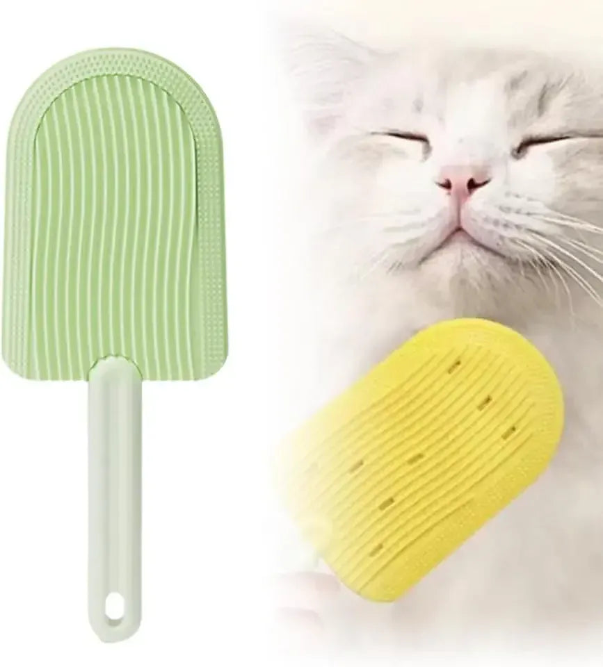 Two silicone pet grooming brushes, one green and one yellow, with a cat in the background.