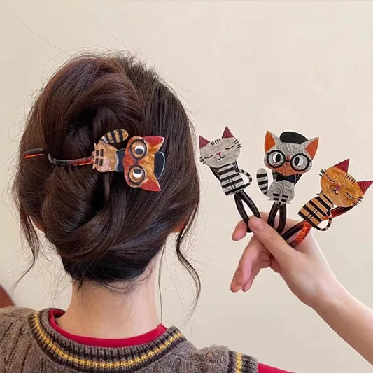 Person styling hair with animal-themed hair clips on a plain background