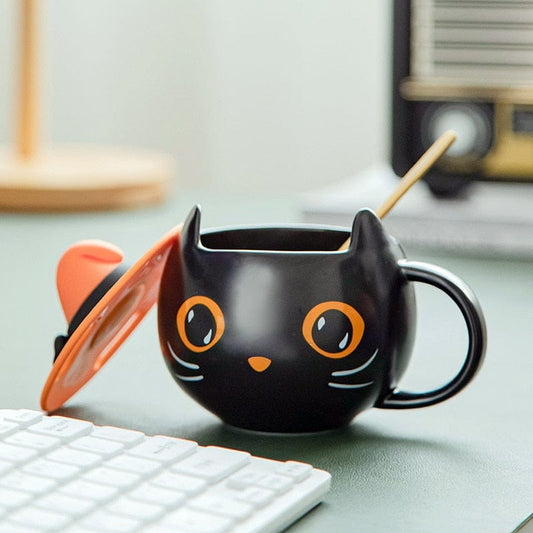 Black Cat Mug on Desk – Pumpkin Eyes & Witch Hat Detail