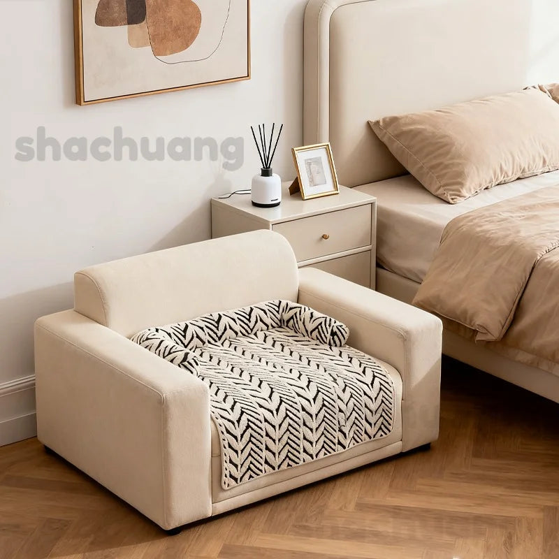 Beige pet bed with zebra pattern blanket in a bedroom setting.
