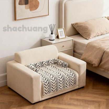 Beige pet bed with zebra pattern blanket in a bedroom setting.