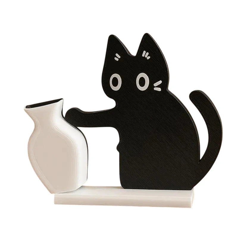 Black cat-shaped bookend holding a white ceramic pitcher on a white background