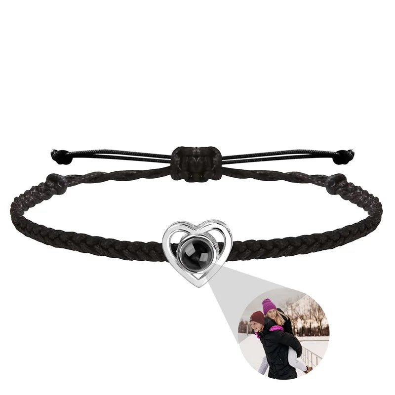 Black braided bracelet with a heart-shaped charm featuring a photo of two people on a white background