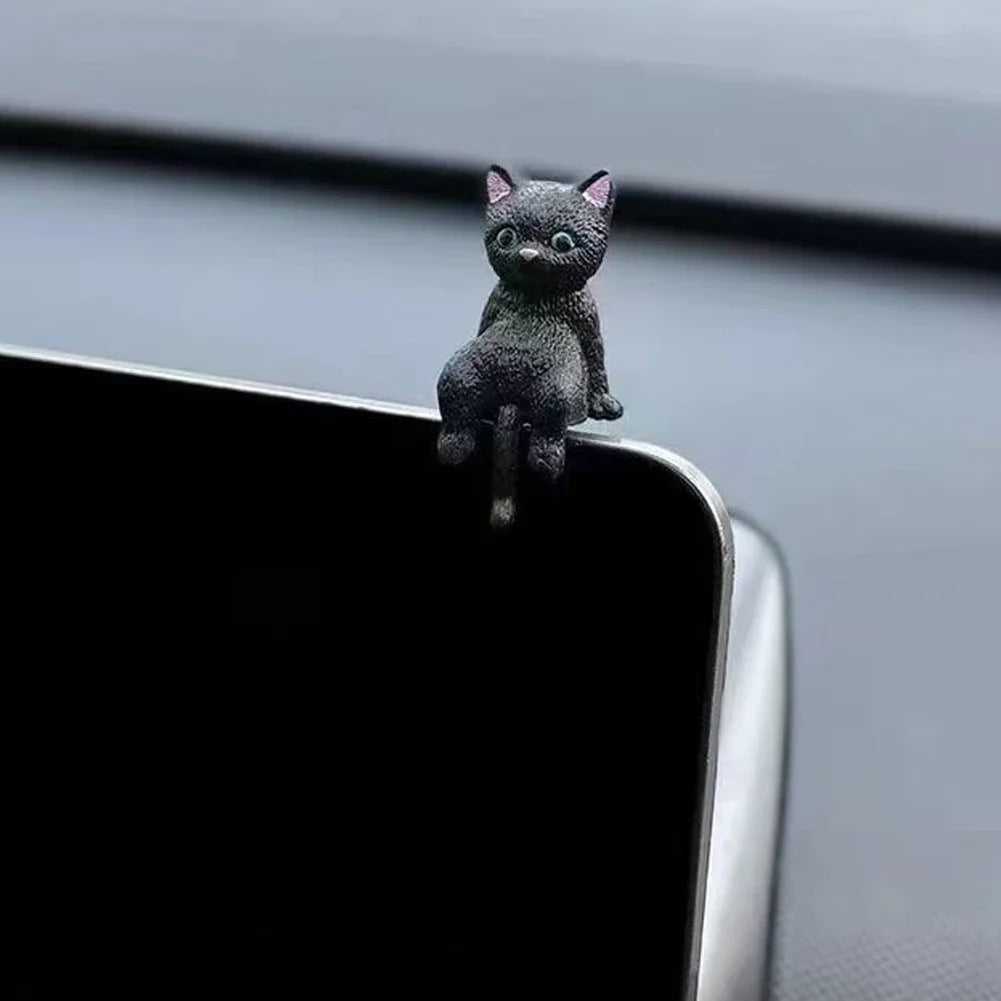 Black cat figurine on a car's rearview mirror