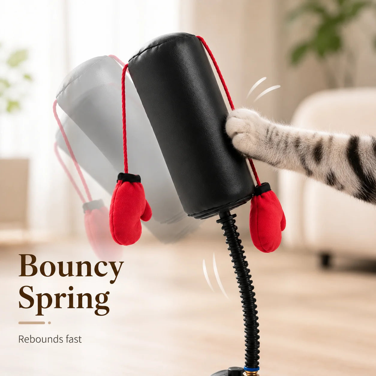Pet toy with red mittens and a bouncy spring, held by a cat's paw.