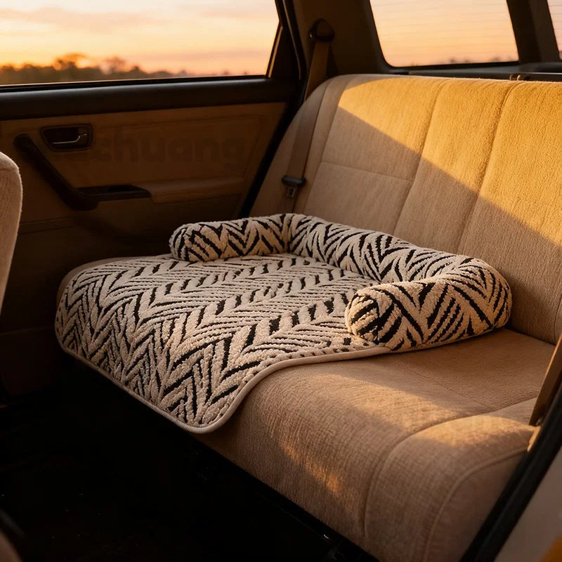 Car seat cover with zebra pattern on a beige car interior during sunset.