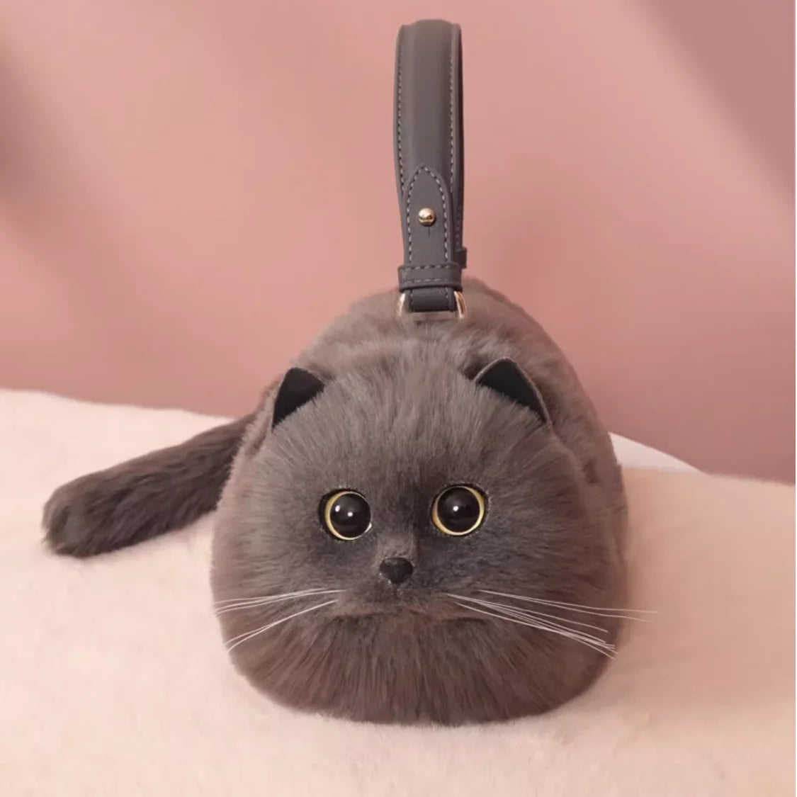 Cat-shaped handbag with a pink background