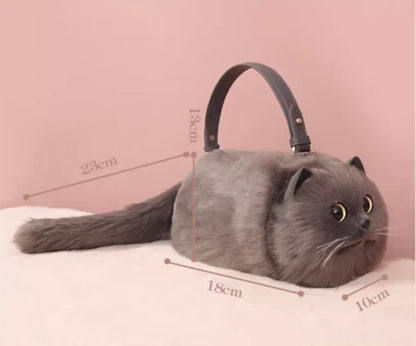 Cat-shaped handbag with measurements on a pink background