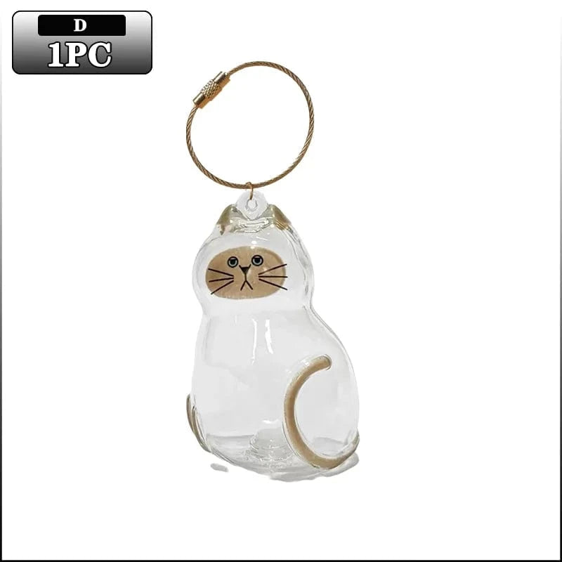 Clear cat-shaped glass ornament with brown accents on a white background