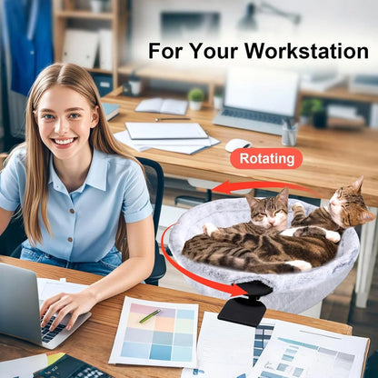 Woman at a workstation with a rotating pet bed for cats on the desk.