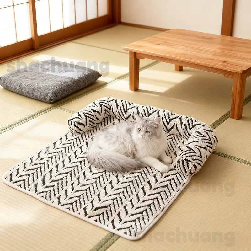 Cat lying on a patterned pet bed in a room with tatami flooring and wooden furniture.