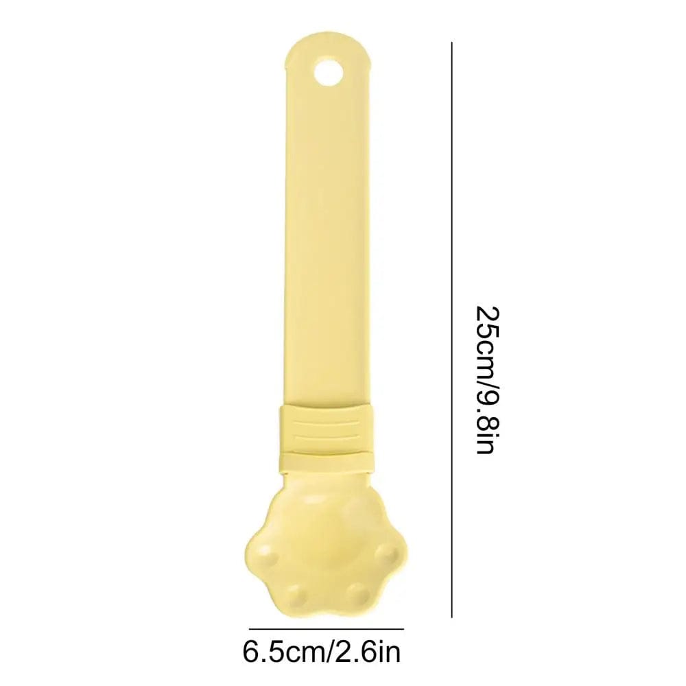 A Cat Strip Squeezer Treat Spoon in yellow