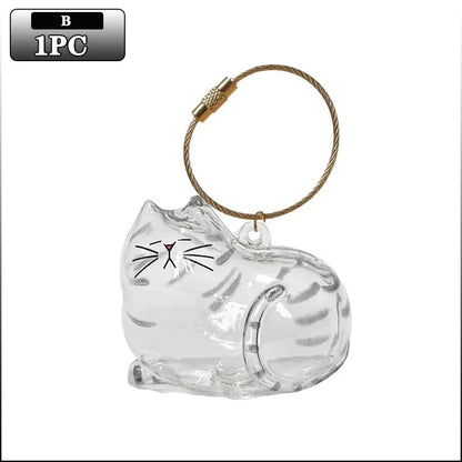 Clear cat-shaped ornament with a gold ring on a white background