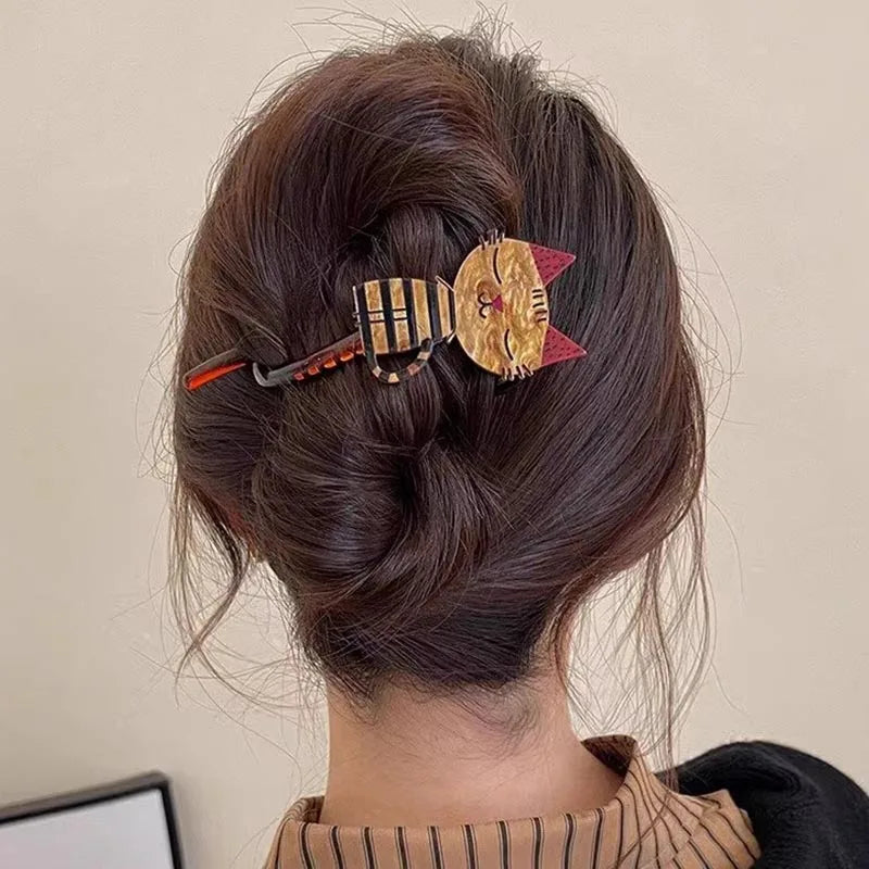 Close-up of a person's hair with decorative hair clip against a neutral background