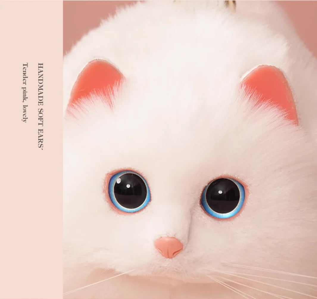Close-up of a white cat toy purse with pink ears and black eyes on a pink background.