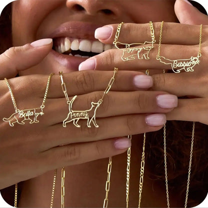 Gold necklaces with cat designs and names on a blurred background
