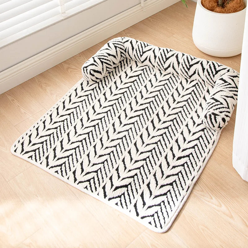 Folded black and white patterned rug on a wooden floor