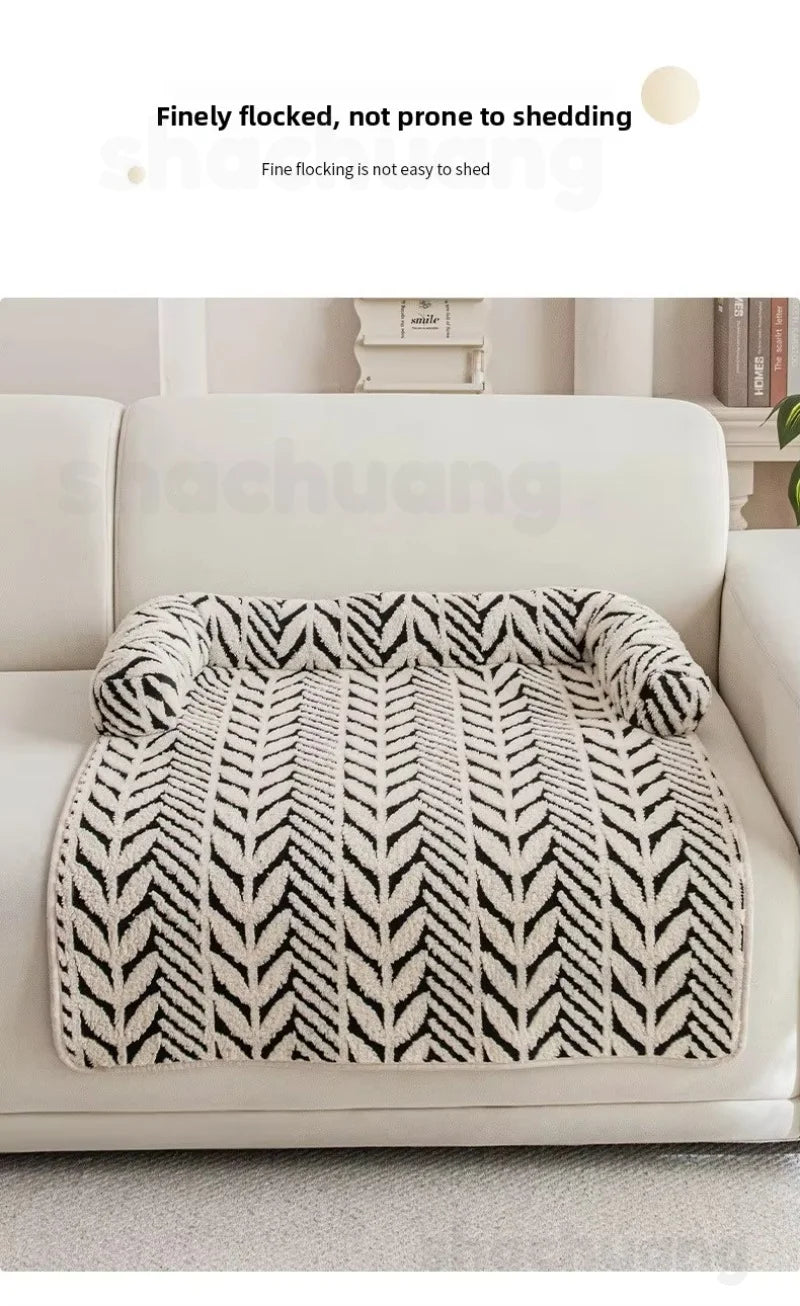 Fluffy blanket with a black and white pattern on a sofa