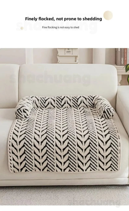 Fluffy blanket with a black and white pattern on a sofa