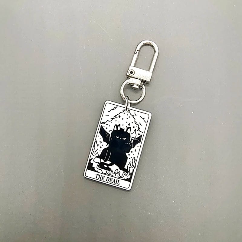 A collection of acrylic keychains featuring black and white tarot card designs with cat imagery.