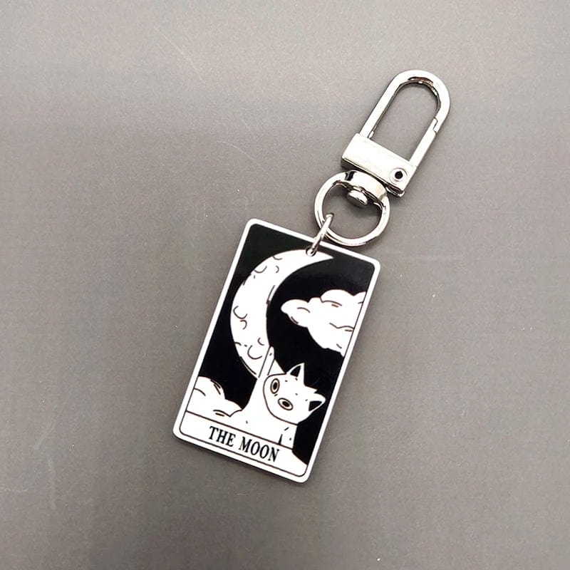 A collection of acrylic keychains featuring black and white tarot card designs with cat imagery.