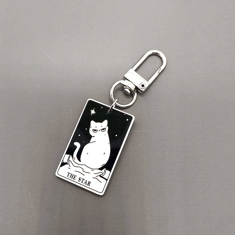 A collection of acrylic keychains featuring black and white tarot card designs with cat imagery.