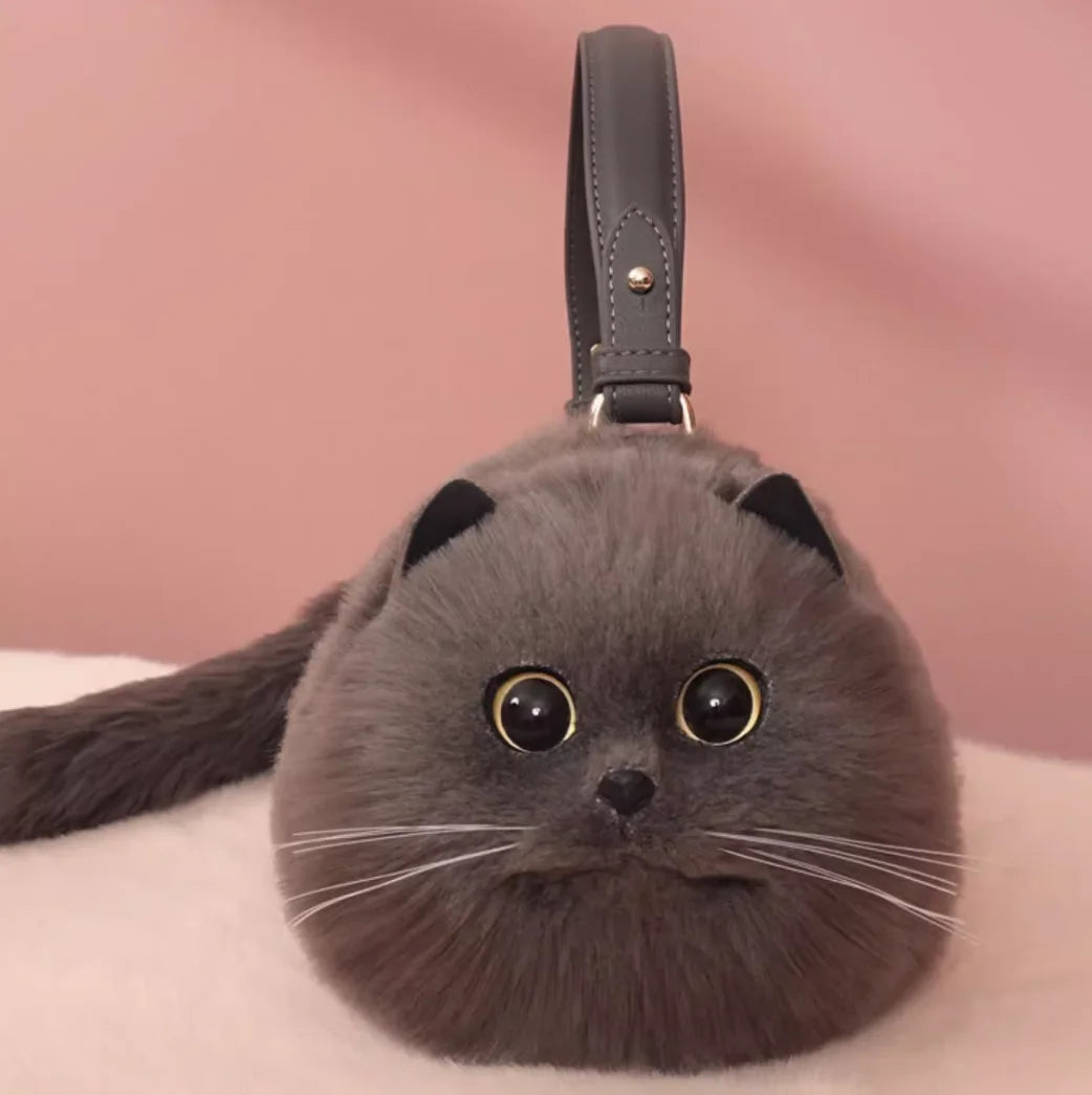 Gray cat-shaped handbag with a pink background
