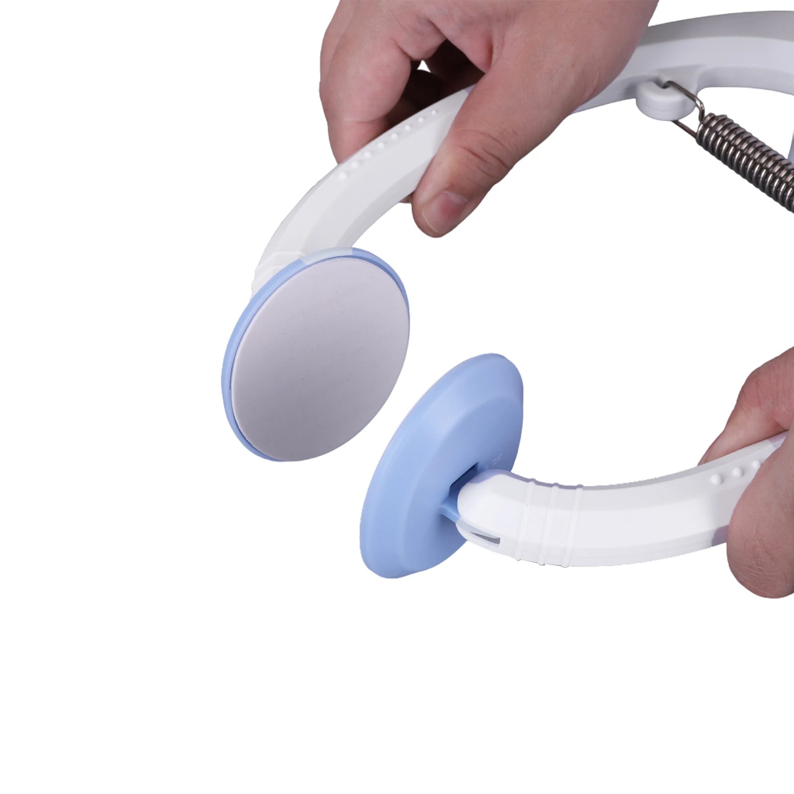 Hand holding a white and blue handheld device on a white background