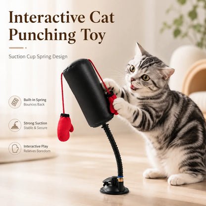 Cat playing with an interactive punching toy on a light surface.