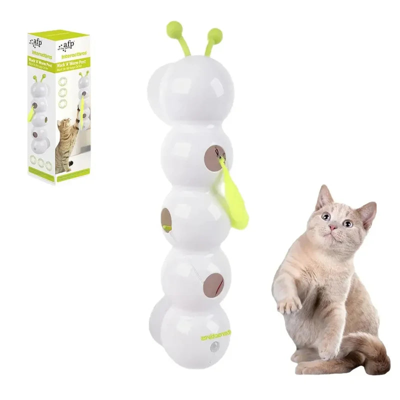 White cat toy shaped like a caterpillar with green antennae, next to a cat and its packaging on a white background.