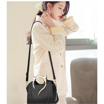 Luxury Cat Ears Shoulder Bag In Black  with a women wearing it 