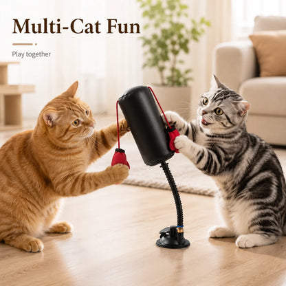 Two cats playing with a cat toy on a wooden floor.