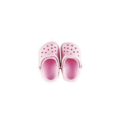 Pair of pink clogs on a white background