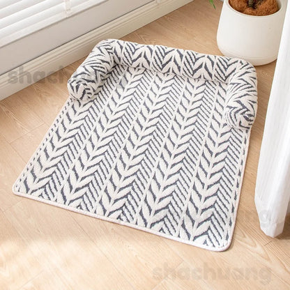 Patterned rug on a wooden floor with a plant in the background