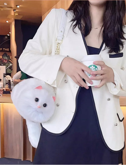 Person holding a plush toy bag and a Starbucks cup in a store setting