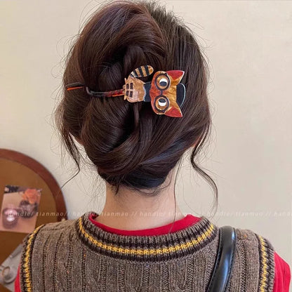 Person with decorative hair clips in their bun against a neutral background