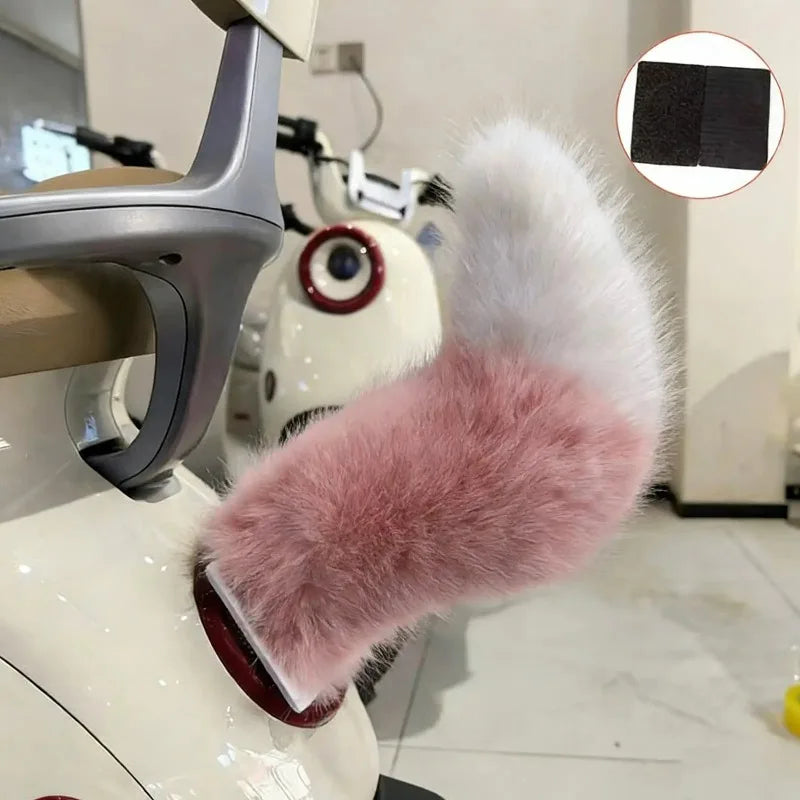 Car air freshener with pink fluffy cover attached to car vent