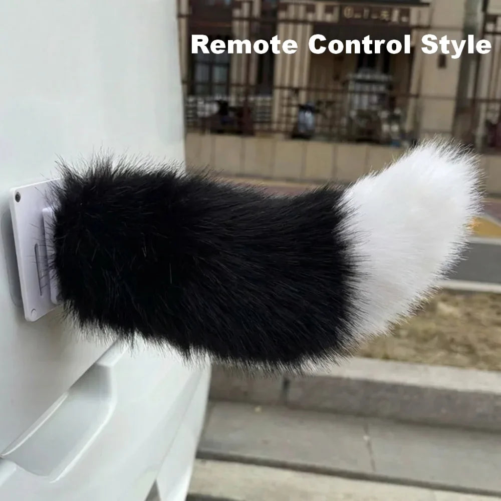 Black and white fluffy remote control-style dog toy attached to a wall.