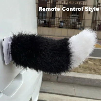 Black and white fluffy remote control-style dog toy attached to a wall.