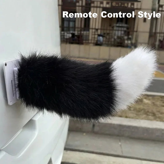 Black and white fluffy remote control-style dog toy attached to a wall.