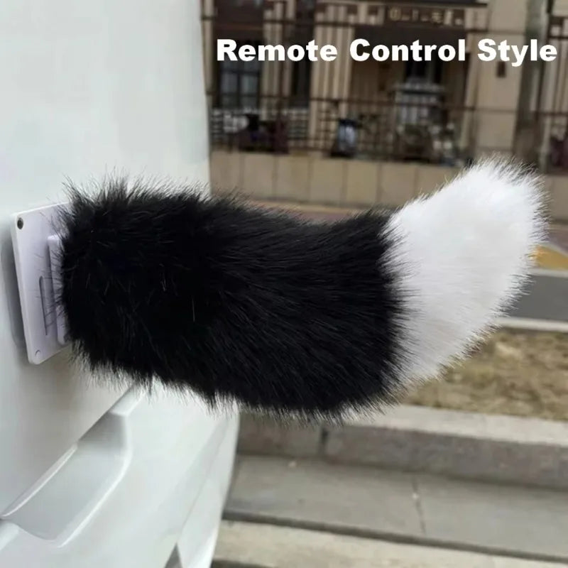 Fur-covered remote control style device attached to a wall with a blurred background.