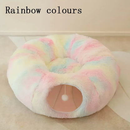 Round, plush pet bed with rainbow colors on a light background