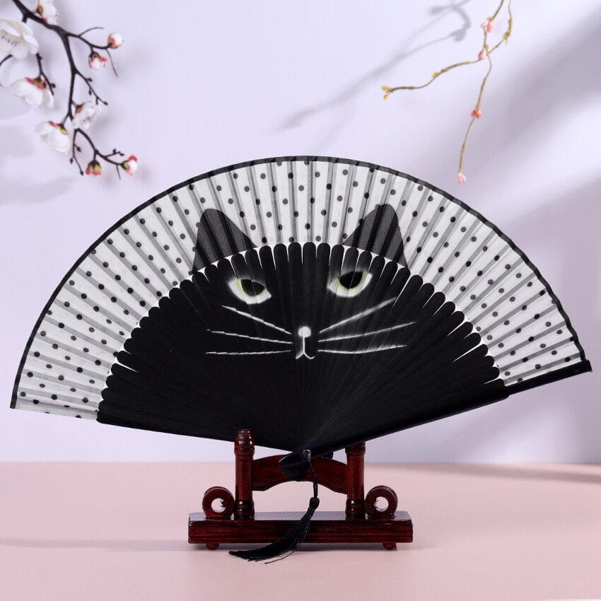 Cute cat motif on a collapsible handheld fan