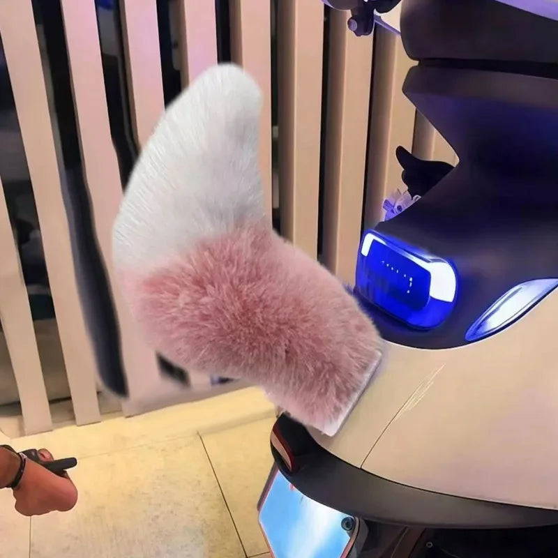 Close-up of a fluffy white and pink object on a scooter with a blurred background