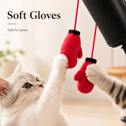 Red gloves on a string with a cat interacting with them, labeled 'Soft Gloves Safe for paws'.