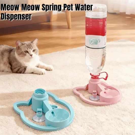 Cat lying on a carpet next to a Meow Meow Spring Pet Water Dispenser with a water bottle.