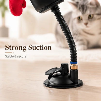 Cat toy with strong suction cup on a wooden surface, cat in the background