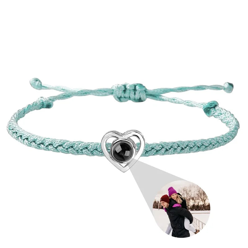 Bracelet with heart-shaped charm and photo pendant on a white background