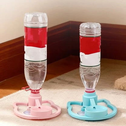 Two pet water bottles with stands, one pink and one blue, on a carpeted floor.